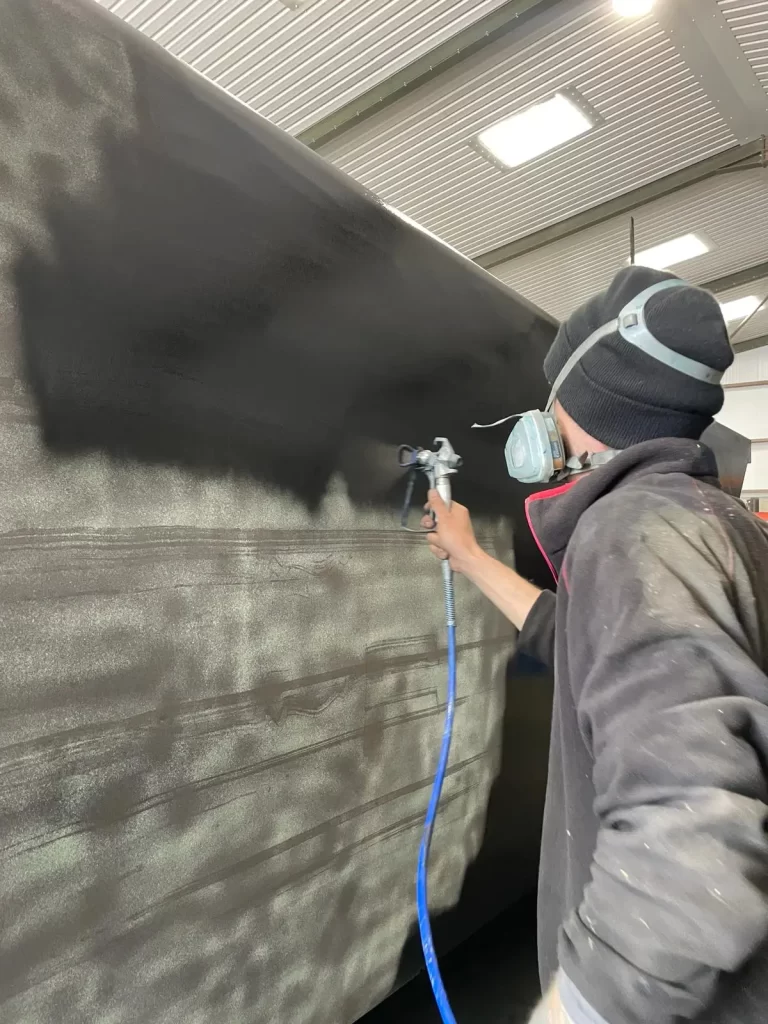 Shot-Blasting-32yd-portable-waste-compactor-first-coat-of-paint-768x1024